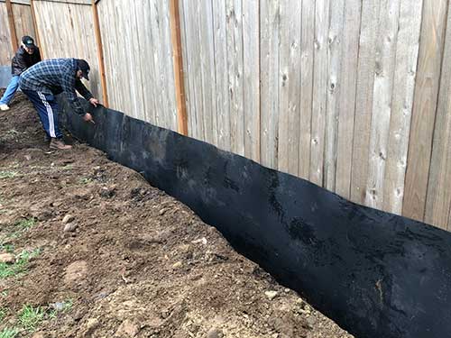 installing HDPE bamboo barrier on a fenceline